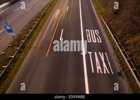 Cars speeding on a highway with motion blur with separated bus and taxi lane on the right Stock Photo