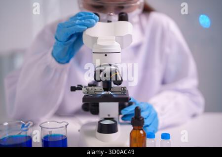 Dedicated adult scientist performs meticulous lab research investigating microscopic organisms Developing medical breakthroughs exploring biological i Stock Photo