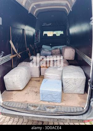 Packed furniture and boxes prepared for moving inside the truck cargo Stock Photo