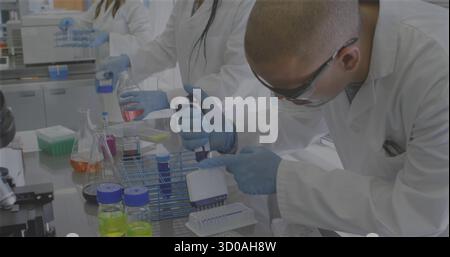 Using multi-channel pipette scientist in lab coat gloves dispensing samples in lab, copy space Stock Photo