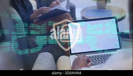 Typing man analyzing scrolling code overlay in office lounge, with laptop and printed documents Stock Photo