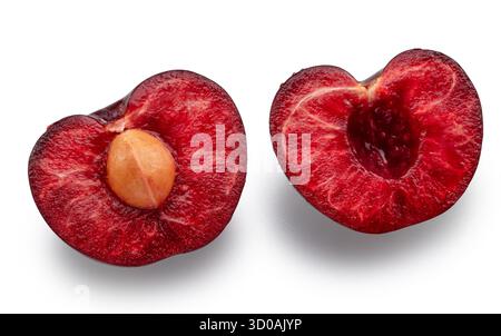 Sweet cherry splitted on two halves isolated on white background. File contains clipping paths. Stock Photo