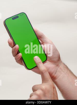 Digital Template: Green Screen Smartphone in Hands Stock Photo