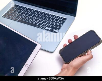 Modern Digital Devices: Laptop, Tablet, and Smartphone in Use Stock Photo