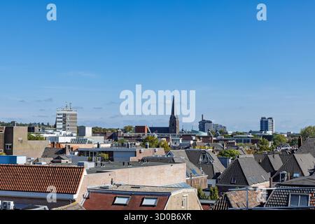 Sunny view over the historic and modern skyline of Arnhem, Netherlands, featuring the prominent spire of the Eusebius Church rising above the city. Stock Photo
