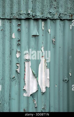 Peeling paintwork on a corrugated steel building Stock Photo