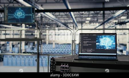 Neural networks tech on notebook in industrial data center facility helping power online websites. AI coding script running on laptop in server farm built for platforms hosting cloud services Stock Photo