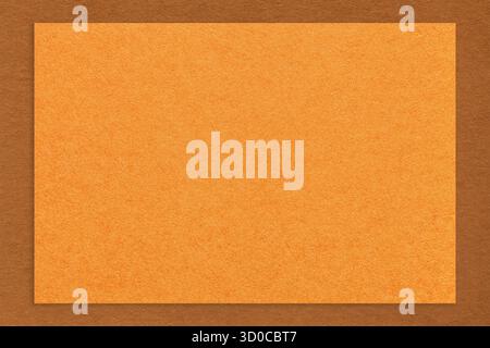 Textured orange paper background with brown border. Vintage kraft cardboard with empty frame. Banner with copy space. Stock Photo
