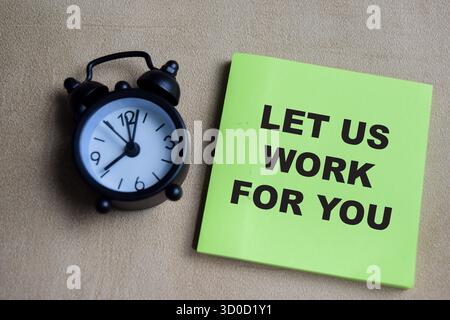 Concept of let us work for you write on sticky notes isolated on Wooden Table. Stock Photo