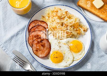 Healthy Homemade Eggs Canadian Bacon and Hash Brown Breakfast with Toast Stock Photo