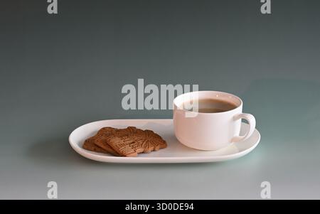 Spiced speculatius on the tablet and a cup of coffee Stock Photo