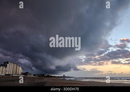 Nieuwpoort, West-Vlaanderen, Belgium, September 13th, 2025, Dark, ominous clouds loom over the beach, beautifully capturing the essence of a dramatic and moody sunset Stock Photo