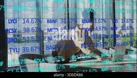 Leaning businesswoman analyzing financial data on laptop in boardroom with data overlay, copy space Stock Photo