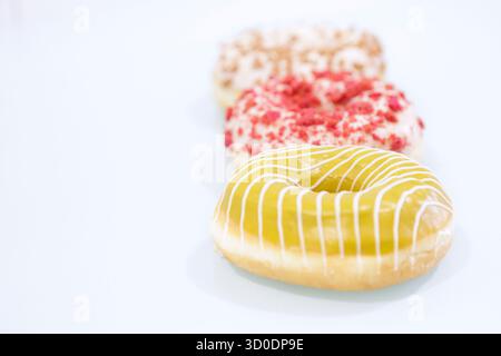 Delicious glazed donuts on white background. Stock Photo
