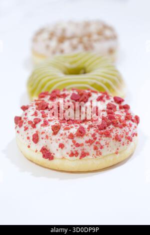 Delicious glazed donuts on white background. Stock Photo