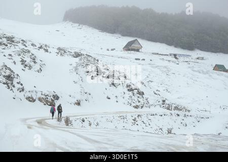 two hikers walking away, katun Vranjak, Bjelasica Mountains, Montenegro Stock Photo