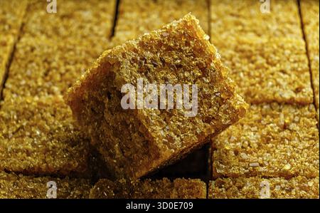 Organic sugar cube macro image. Sugar cube on top of other cubes in pack Stock Photo