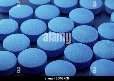Blue tablet background, drug roofie ox extasy bought on dark web Stock Photo