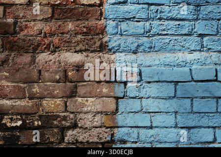 Weathered Half Painted In Blue Brick Wall Stock Photo