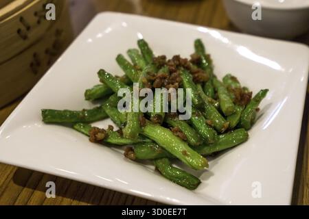 Traditional chinese cuisine minced beef over bean sprouts served in a white plate Stock Photo