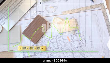 Displaying first-floor blueprint covering studio desk, featuring grid overlay and spirit level Stock Photo