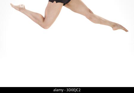 Close-up view on egs of the woman jumping on a white background Stock Photo