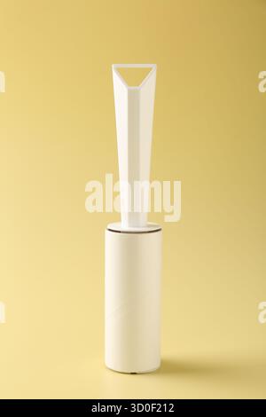 One lint roller on yellow background, closeup Stock Photo