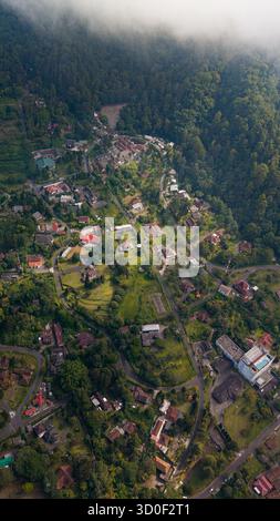 Aerial view of Kaliurang in the lush mountainous landscape with dense ...