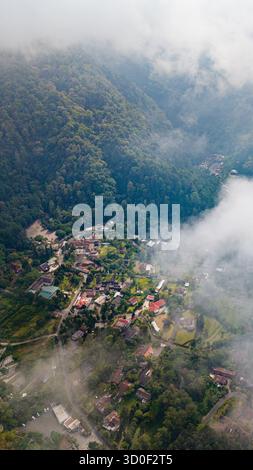Aerial view of Kaliurang in the lush mountainous landscape with dense ...