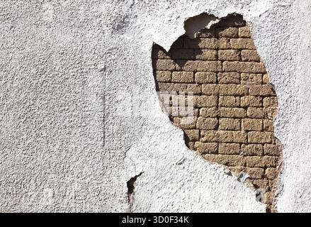 Structural damage, wall damage, flaking plaster and wall paint, bricks Stock Photo