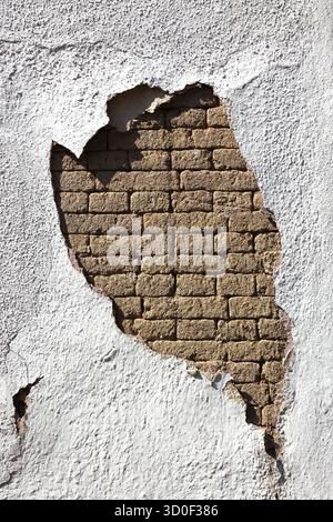 Structural damage, wall damage, flaking plaster and wall paint, bricks Stock Photo