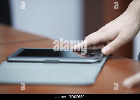 Human hand using tablet computer Stock Photo