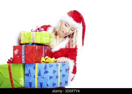 Blong in the red Santa costume holding colorful boxes with Xmas gifts Stock Photo