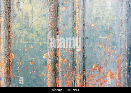 Old painted wooden surface with peeling turquoise and orange texture. Background. Stock Photo