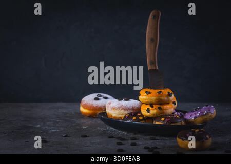 Halloween donuts on kitchen table, in dark colors Stock Photo