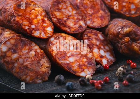 Detail of traditional Spanish sausage Fuet Salami on wooden background Stock Photo