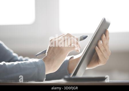 Hands of human using digital tablet and stylus Stock Photo