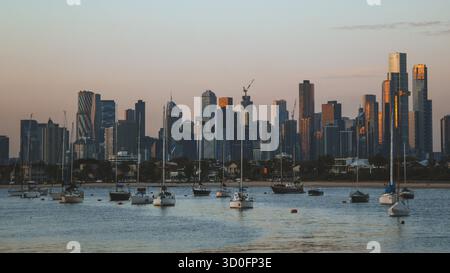 St Kilda Melbourne, Victoria Australia - Mar 14 2025: Golden Sunset over the Melbourne CBD Skyline from St Kilda Stock Photo