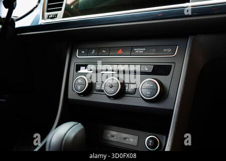 New car climate control panel with plastic knobs, buttons and dials. Close up shot, no people Stock Photo