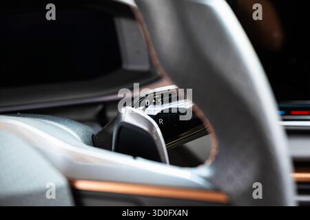 Small, steering column mounted automatic gearbox shifter lever on a new car. Close up shot, shallow depth of field, no people Stock Photo
