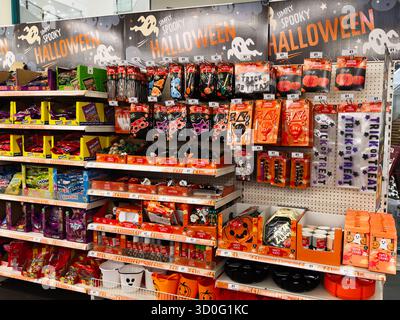 Manchester, UK - September 26, 2025: Vibrant Halloween merchandise on shelves including candy, masks, decorations and themed party favors. Stock Photo