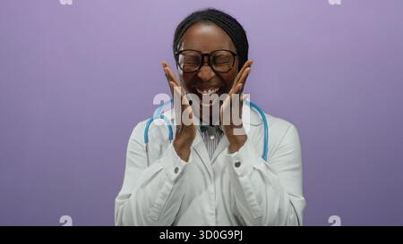 Smiling woman doctor with glasses and stethoscope on purple background radiating happiness and confidence in her profession. Stock Photo