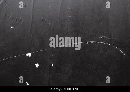 Black wheatpaste street poster with crease lines and white scratch marks texture Stock Photo