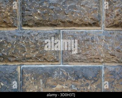 Historic rusticated stone wall with irregular, rough blocks. Close-up. Copyspace. Stock Photo