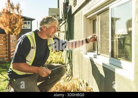 inspector or engineer is checking the building structure and house. After the renovate is complete Stock Photo