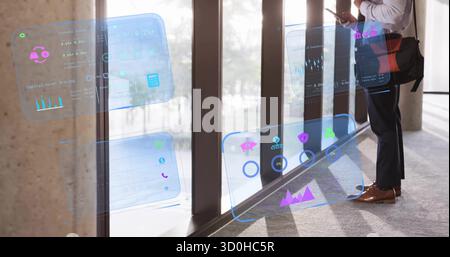 Professional checking smartphone in office hallway with bag, holographic charts, copy space Stock Photo