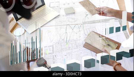 Reviewing two architects collaborating over blueprints at design studio desk, with tablet and ruler Stock Photo