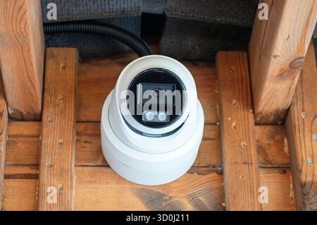 Security camera mounted on a wooden structure. Stock Photo