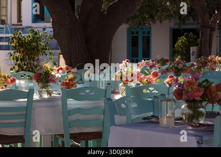 Table settings with flowers for an Italian wedding in the village of Chora - Folegandros Island, Cyclades Islands, Greece Stock Photo