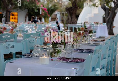 Table settings with flowers for an Italian wedding in the village of Chora - Folegandros Island, Cyclades Islands, Greece Stock Photo